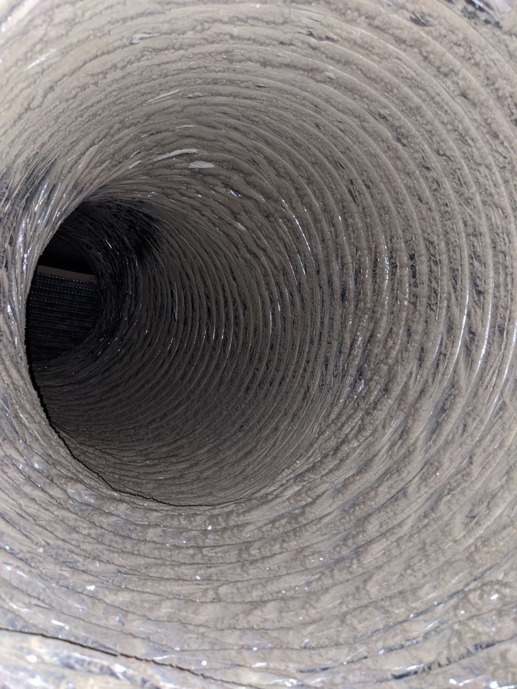 Supply run in a DFW home. Years of dust bonded to the liner, blowing into the bedroom every cycle.